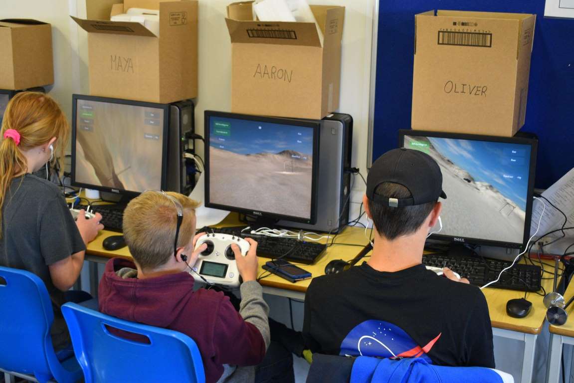 Students at Tech Camp flying a drone racing simulator