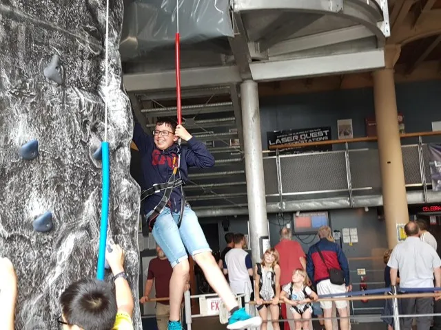 Boy at climbing wall during weekend trip for 'Bridge Weekend' Tech Campers